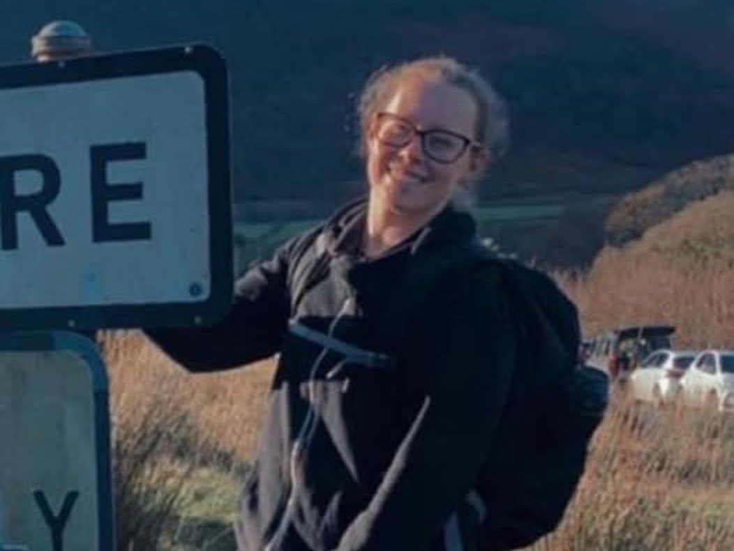 Meg, our new part-time groomer, smiling in the hills